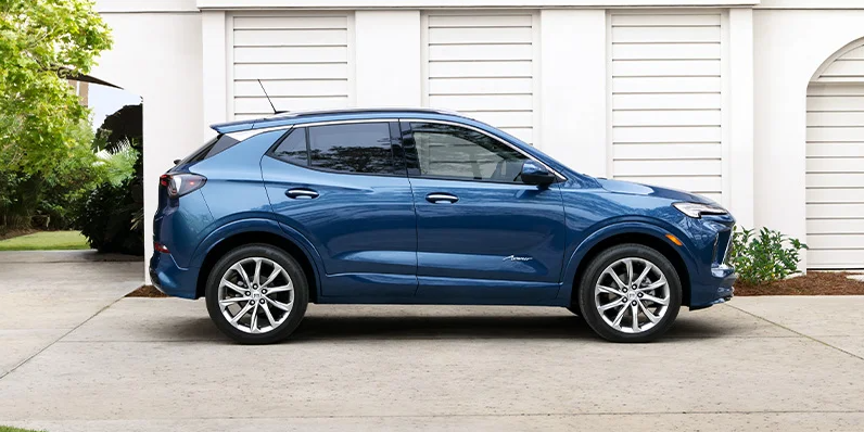 A blue 2025 Buick Encore GX parked in the driveway.